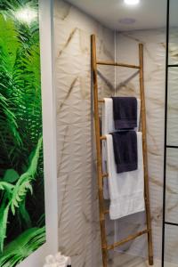 a towel rack in a bathroom with green plants at luxury dome tents ikaria ap'esso in Raches