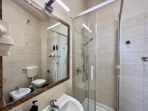 a bathroom with a shower and a toilet and a sink at Be Your Home - Guest House Fuori Dal Porto in Civitavecchia +40 photos