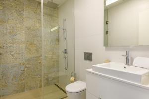 a bathroom with a sink and a toilet and a shower at Las Colinas Golf & Country Club Residences in Orihuela Costa