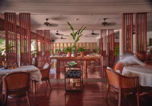 a restaurant with tables and chairs in a room at La Résidence Phou Vao, A Belmond Hotel, Luang Prabang in Luang Prabang