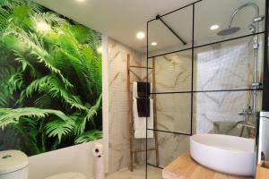 a bathroom with a large mural of plants on the wall at luxury dome tents ikaria ap'esso in Raches