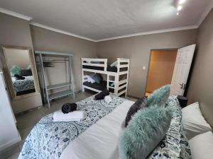 a bedroom with a bed and two bunk beds at Bella Vista at Village-Living in Koringberg +22 photos