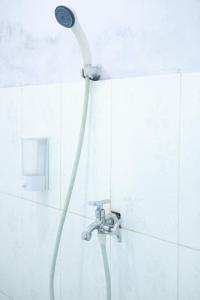 a shower with a shower head in a bathroom at Mentigen Homestay in Ngadisari