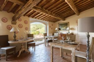 a living room with a table and chairs and a window at Dimora Santa Margherita - Boutique Hotel in Cinigiano