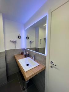 a bathroom with a sink and a mirror at Gloria Maris Apartment in Menton