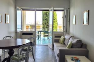 a living room with a couch and a table at Vista Bella House in Sanremo