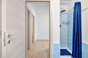 a bathroom with a shower and a glass door at Appartamento Caterina in Siniscola