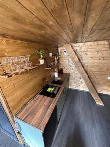 a kitchen with wooden walls and a wooden counter top at Alagi Cottage Kazbegi in Stepantsminda