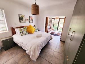 a bedroom with a large bed in a room at Buff and Fellow by the Bay in Groot Brak Rivier