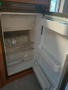 an open refrigerator with a bottle of water in it at TerraOliva&herbs in Vátos