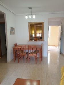 a kitchen and dining room with a table and chairs at Costa Caribe III Nº 1108 in Oropesa del Mar