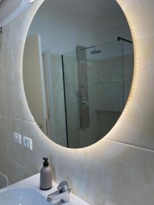 a bathroom with a mirror and a sink and a shower at NÓS apartment 1 in Shkodër