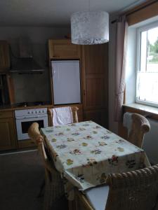 a kitchen with a table with a table cloth on it at Ferienwohnung Am Himmel in Birx