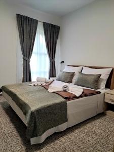 a bedroom with a large bed with a window at Eco-selo Grabovica in Grabovica
