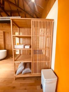 a wooden bunk bed in a room with a toilet at Meet Forty Homestay in Tainan
