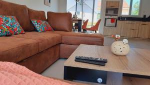 a living room with a brown couch and a coffee table at La Bucolique in Simandre +17 photos