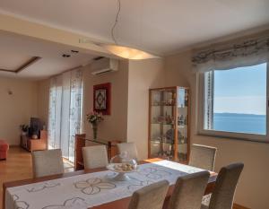 a dining room with a table and chairs at SEA VIEW- spacious apartment with shared pool in Split