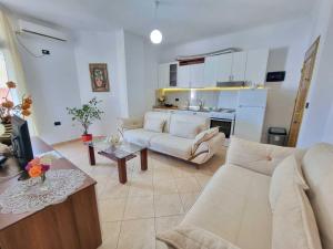 a living room with a couch and a table at Friendly Apartment Golem in Golem