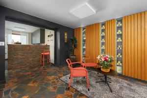 a tasting room with red chairs and a counter at Hotel Premier- Adults Only in Bedřichov