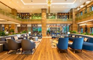 a lobby of a hotel with couches and chairs at Express Inn The Business Luxury Hotel in Nashik