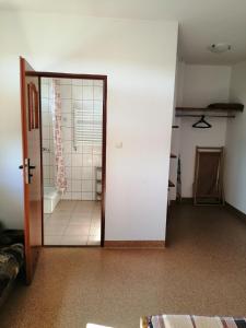 Zimmer mit einer Tür zum Bad in der Unterkunft Pokoje Gościnne Grzybowo in Grzybowo