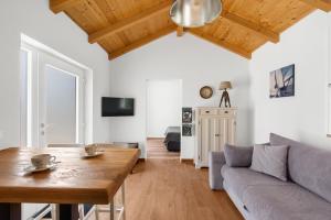 a living room with a wooden table and a couch at Casa Cosini with Private Pool in Poreč