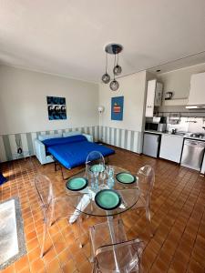 a living room with a blue bed and a table and chairs at Casa Sabaudia in Turin