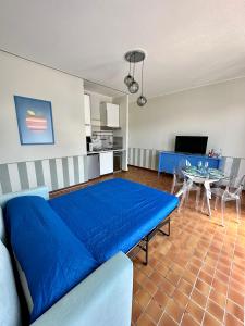 a living room with a blue couch and a table at Casa Sabaudia in Turin