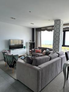 TV a/nebo společenská místnost v ubytování DÚPLEX DE LUJO EN FOZ CON VISTAS al MAR