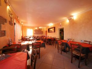 a restaurant with tables and chairs with red tables at Casa Stella vicinanze Maranello in Casa Stella