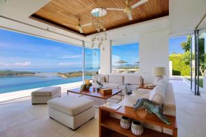 a living room with a view of the ocean at Villa Natha in Choeng Mon Beach