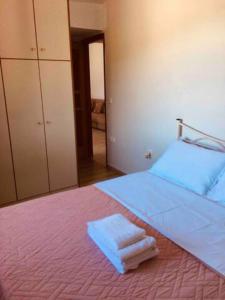 a bedroom with a large bed with towels on it at house with sea and mountain view in Rozená