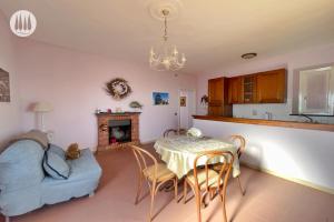 a living room with a table and a couch at Agriturismo Irto Colle in Massa e Cozzile
