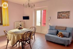 a living room with a table and a blue couch at Agriturismo Irto Colle in Massa e Cozzile
