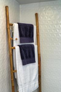 a towel rack in a bathroom with blue and white towels at luxury dome tents ikaria ap'esso2 in Raches