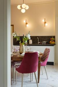 a dining room with a table and purple chairs at Leopoldo in Baveno