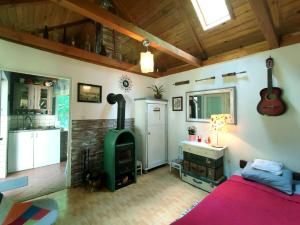 a bedroom with a bed and a wood stove at Domek nad Poranną Rosą in Garbatka-Letnisko +20 photos