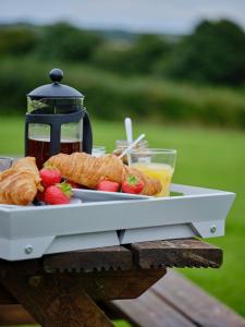 a plate of pastries and fruit on a table at The Granary in Bideford