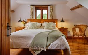 a bedroom with a large bed and a window at The Granary in Bideford
