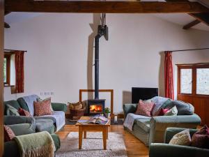 a living room with two couches and a fireplace at The Granary in Bideford
