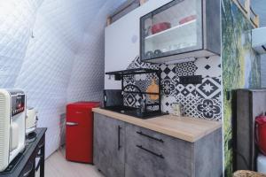 a kitchen with a counter and a refrigerator at luxury dome tents ikaria ap'esso2 in Raches