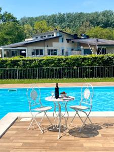 a table and two chairs next to a pool at Casa Vacanze Alessandro in Spinone Al Lago