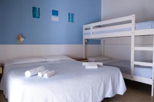 a bedroom with a bed with two bunk beds at Hotel Vienna in Cervia