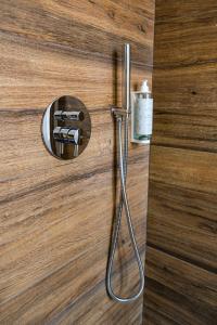 a door with a shower handle on a wooden wall at Hotel Vienna in Cervia