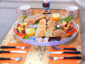 a table with a tray of breakfast foods and drinks at Sailor's small studio in Corfu