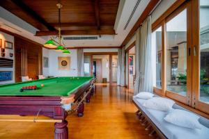 a room with a pool table in a house at The Mantra Luxury Villa in Rawai Beach