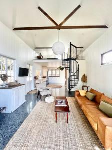 a living room with a couch and a table at The Old Shop - Byron Region Hinterland 