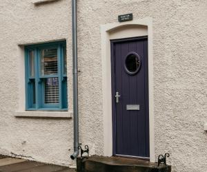 a purple door and a window on a building at The Old Brewery, Ulverston in Ulverston