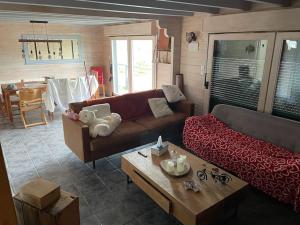 a living room with a couch and a coffee table at Le chalet blanc de Gerardmer avec Spa in Gérardmer