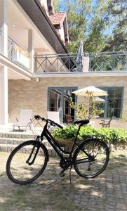 a bike parked in front of a house at Polskie Morze Apartamenty & Pokoje in Pobierowo